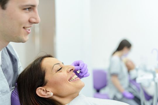 Dentist showing a patient the options for veneers at Dr. James A. Vette, DDS, a dentist in Germantown, MD